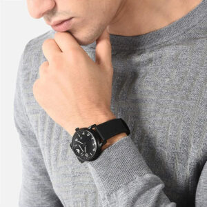 Man wearing Emporio Armani Luigi Slim black watch with black rubber strap on wrist