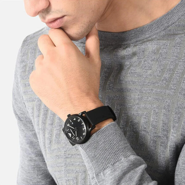 Man wearing Emporio Armani Luigi Slim black watch with black rubber strap on wrist