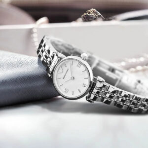 Emporio Armani AR1763 watch styled on gray fabric with jewelry, white dial and silver bracelet
