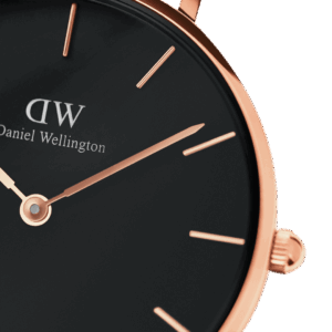 Close-up of black dial with rose gold indexes and hands, DW logo visible