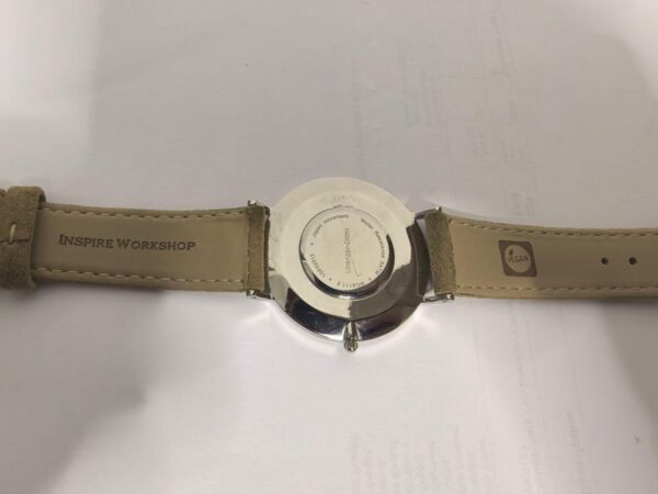 Lorenzen Dilimi watch caseback with engraved text and leather strap