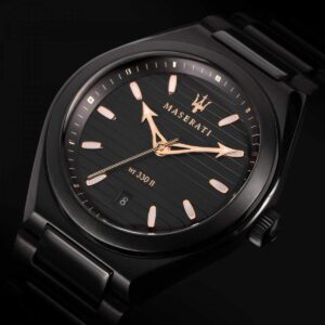 Close-up of black dial showing Maserati branding, gold hands, and water resistance marking