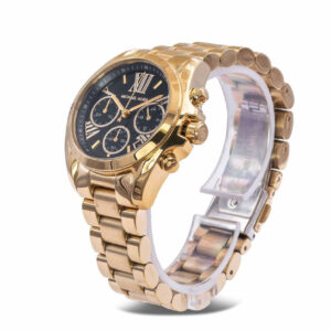 Side angle view of Michael Kors Bradshaw watch showing gold bracelet and black chronograph dial