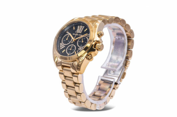 Side angle view of Michael Kors Bradshaw watch showing gold bracelet and black chronograph dial
