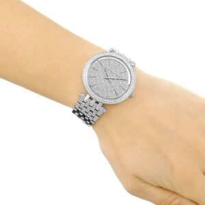 Michael Kors Darci silver-tone watch worn on wrist with crystal pave bezel