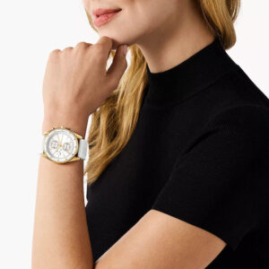 Michael Kors Hadyn MK7484 gold chronograph watch worn on wrist with white strap