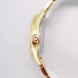 Side view of Michael Kors MK7090 watch showing gold-tone case with crystal bezel and metal strap