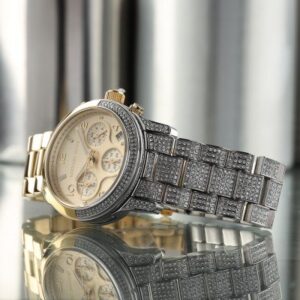 Angled view of MK7329 Runway chronograph with cream dial and crystal-set bezel details
