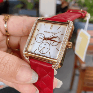Michael Kors Pyper MK2770 watch worn on wrist with red leather strap and gold case