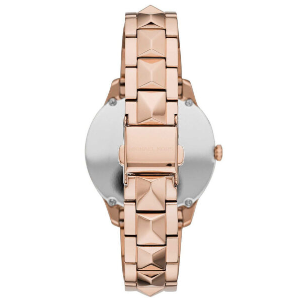 Back view of Michael Kors Runway Mercer watch with caseback and rose gold pyramid stud bracelet