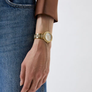 Michael Kors Taryn gold-tone watch worn on wrist with mother-of-pearl dial