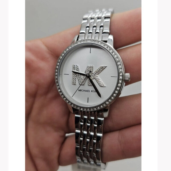 Michael Kors St. Moritz women's watch worn on wrist showing silver-tone bracelet and dial