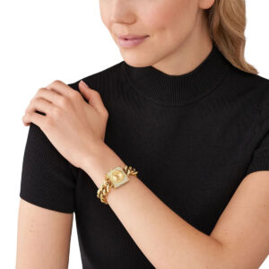 Michael Kors Chain Lock watch worn on wrist, displaying gold crystal-studded square case