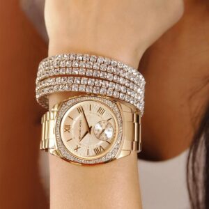 Michael Kors Bryn gold watch worn on wrist with gold metal bracelet