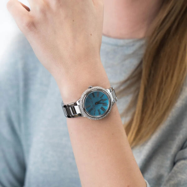 Michael Kors Mini Taryn blue dial watch styled on wrist with silver bracelet