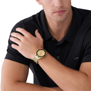 Michael Kors Everest MK9083 gold watch worn on wrist with black dress shirt
