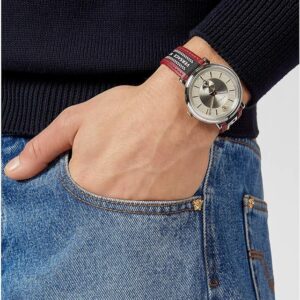 Versace V Circle watch worn on wrist with navy sweater and denim