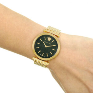 Versace V-Twist watch worn on wrist showing black dial and gold mesh bracelet